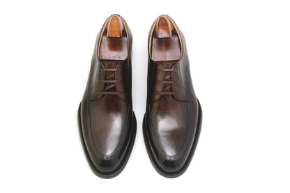 Overhead view of a pair of HolloShoe Hand-Burnished Chestnut Split-Toe Derby shoes with shoe trees, showcasing their rich burnished chestnut leather.