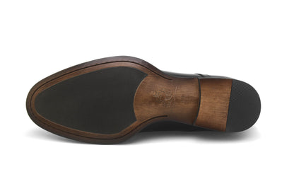 Underside of a HolloShoe Hand-Burnished Chestnut Split-Toe Derby shoe, showing the leather sole with a rubber insert for traction.