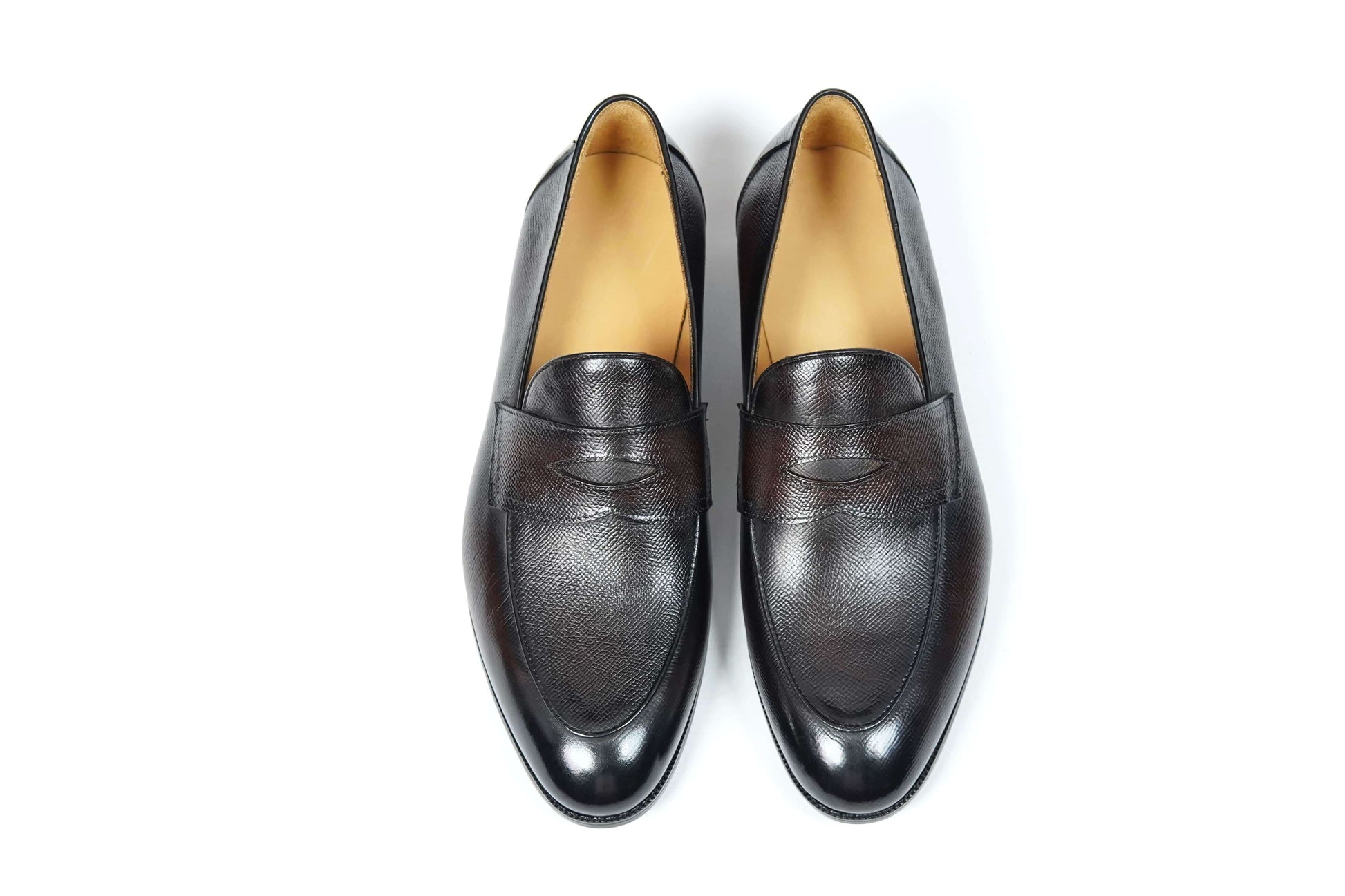 Hand-Finished Espresso Brown Leather Penny Loafers – top-down view of pair on white background, emphasizing textured full-grain leather and minimalist penny strap detail.