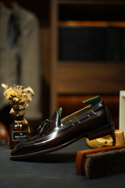 Hand-Made Dark Brown Leather Tassel Loafers – side view with shoe tree and shoe brushes, highlighting hand-painted patina finish and sleek silhouette.