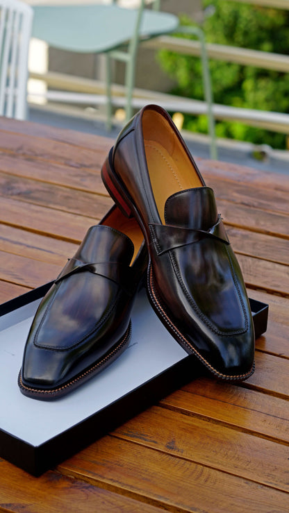 Hand-Painted Dark Brown Leather Penny Loafers – pair on a wooden table in a box, highlighting hand-painted patina and sleek chisel toe.