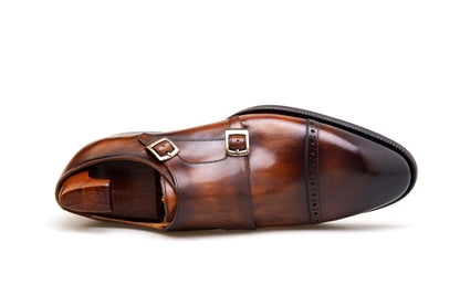 Hand-Polished Brown Double Monk Strap Shoe – top-down view with shoe tree, showcasing rich marbled patina and subtle cap-toe perforations.