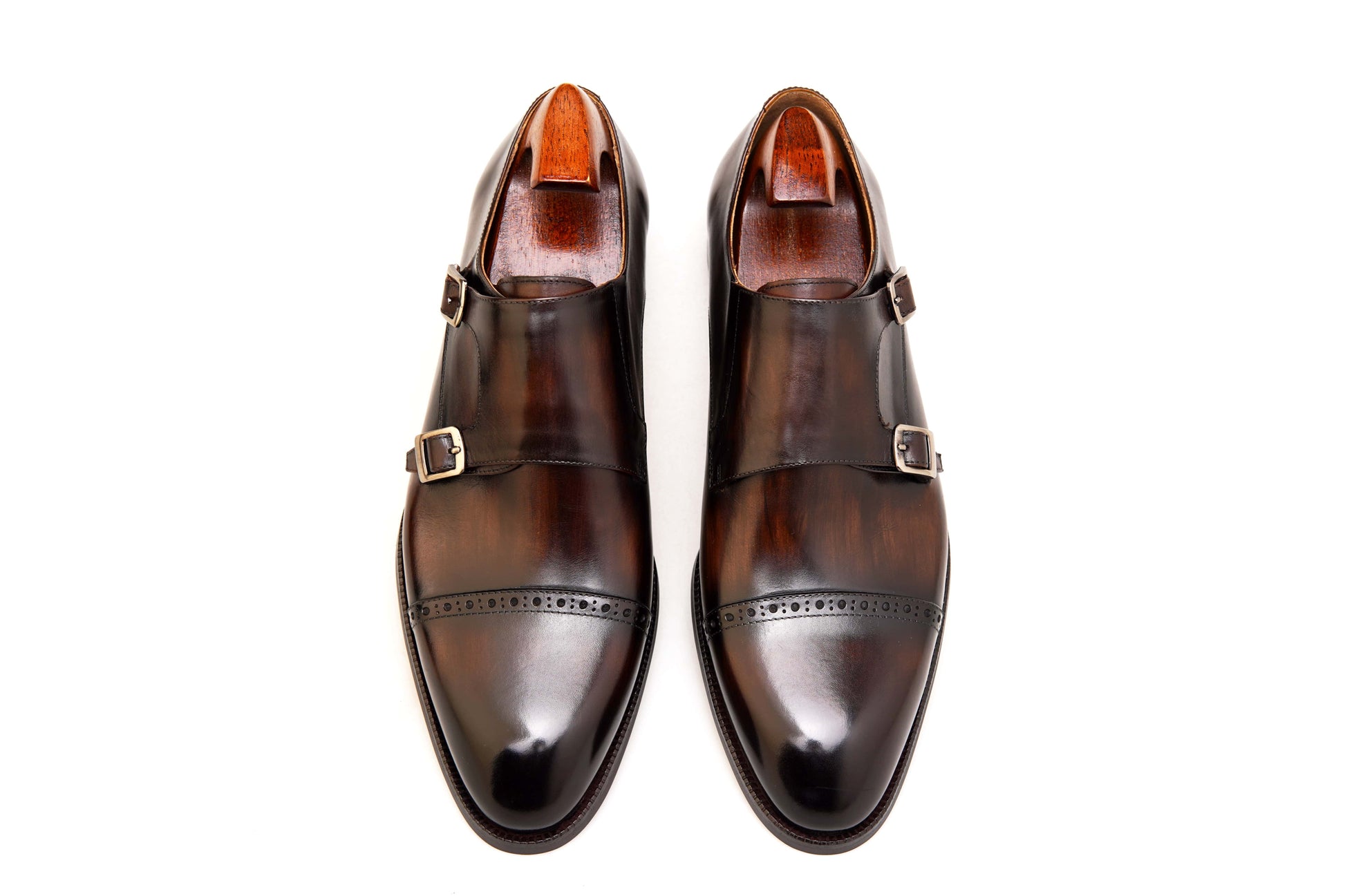 Hand-Polished Smoked Chocolate Double Monk Strap Shoes – pair with shoe trees, top-down view, emphasizing sophisticated "Smoked Chocolate" finish and double buckles.