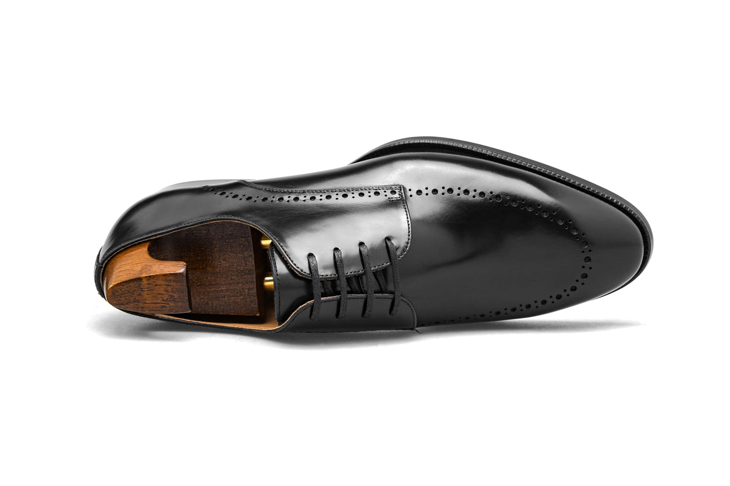 Polished Black Half-Brogue Derby shoe – high-shine leather finish, side view with shoe tree and elegant broguing. 
