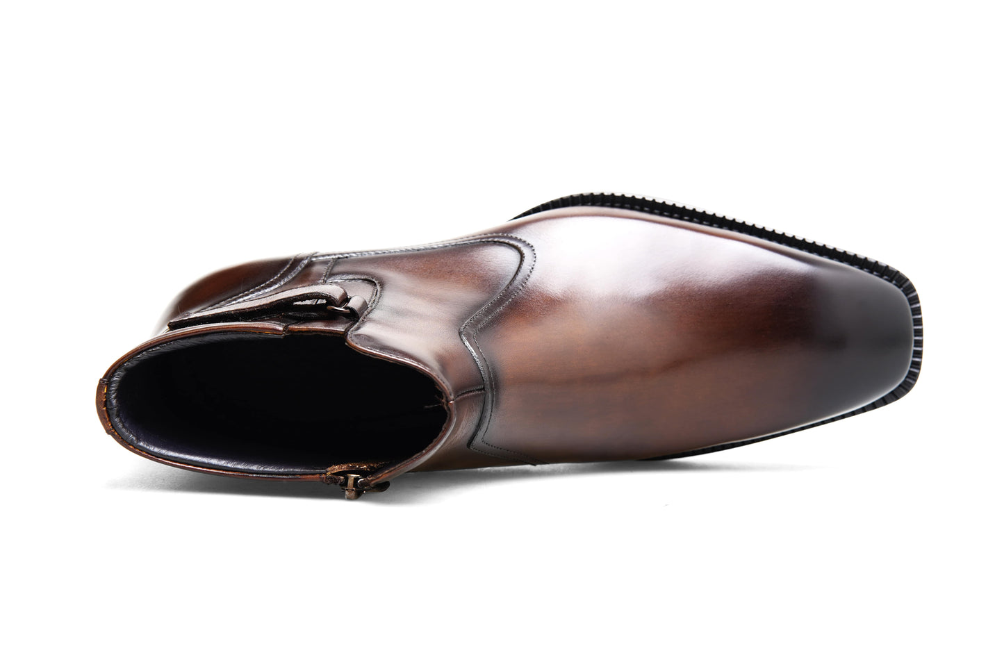 Handcrafted Brown Leather Zip-Up Ankle Boots with Buckle Detail – a top-down view of a single brown leather boot on a white background, showcasing the zip and buckle detail.