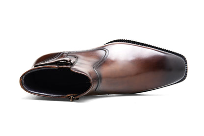 Handcrafted Brown Leather Zip-Up Ankle Boots with Buckle Detail – a top-down view of a single brown leather boot on a white background, showcasing the zip and buckle detail.