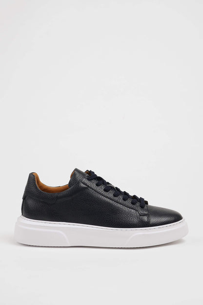 Handcrafted Navy Grained Leather Sneaker with Pool Sole – side view on white background, showcasing low-top design, navy blue leather, and a contrasting white sole.