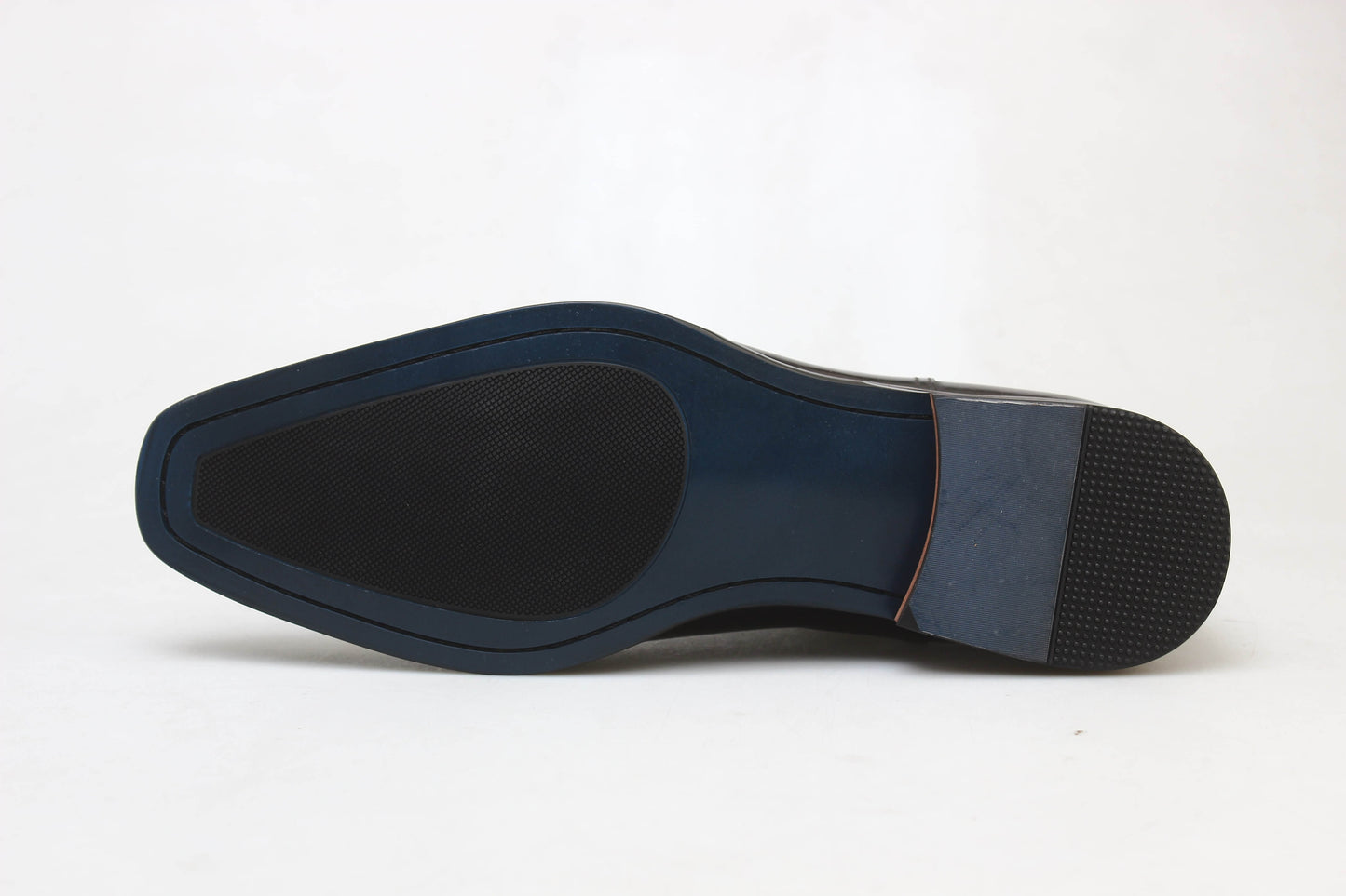 Handcrafted Polished Brown Leather Chelsea Boots for Sophisticated Style – a close-up shot of the blue and black leather and rubber hybrid sole on a white background.