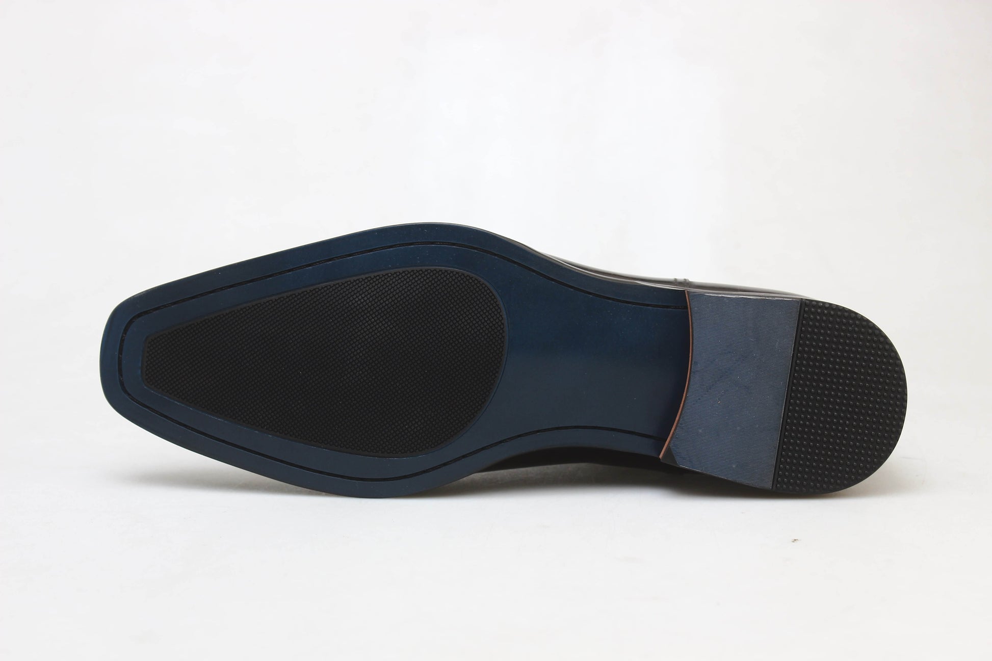 Handcrafted Polished Brown Leather Chelsea Boots for Sophisticated Style – a close-up shot of the blue and black leather and rubber hybrid sole on a white background.