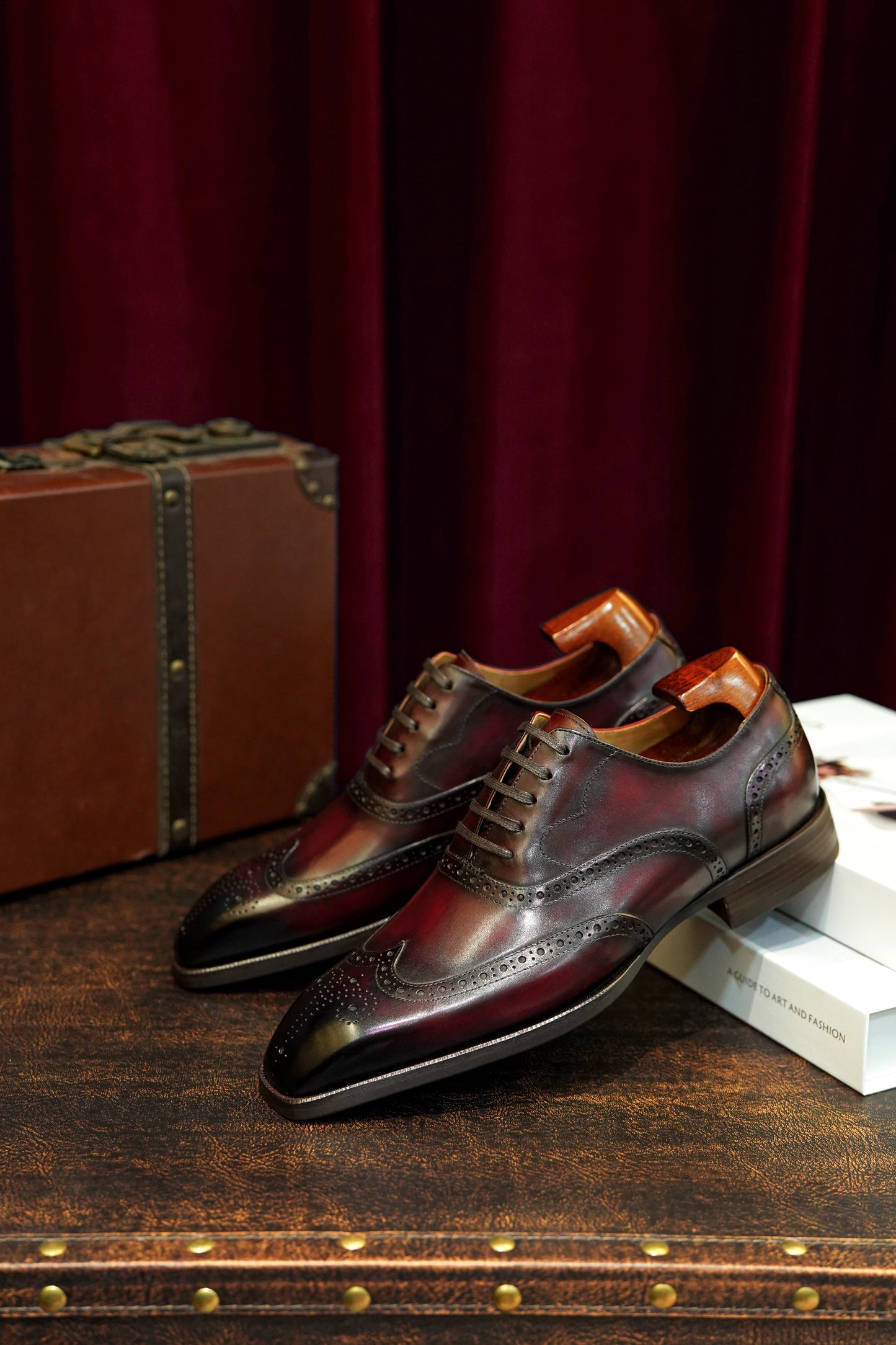 Hand-finished men’s dress shoes Burgundy Oxford brogues – angled lifestyle shot on trunk