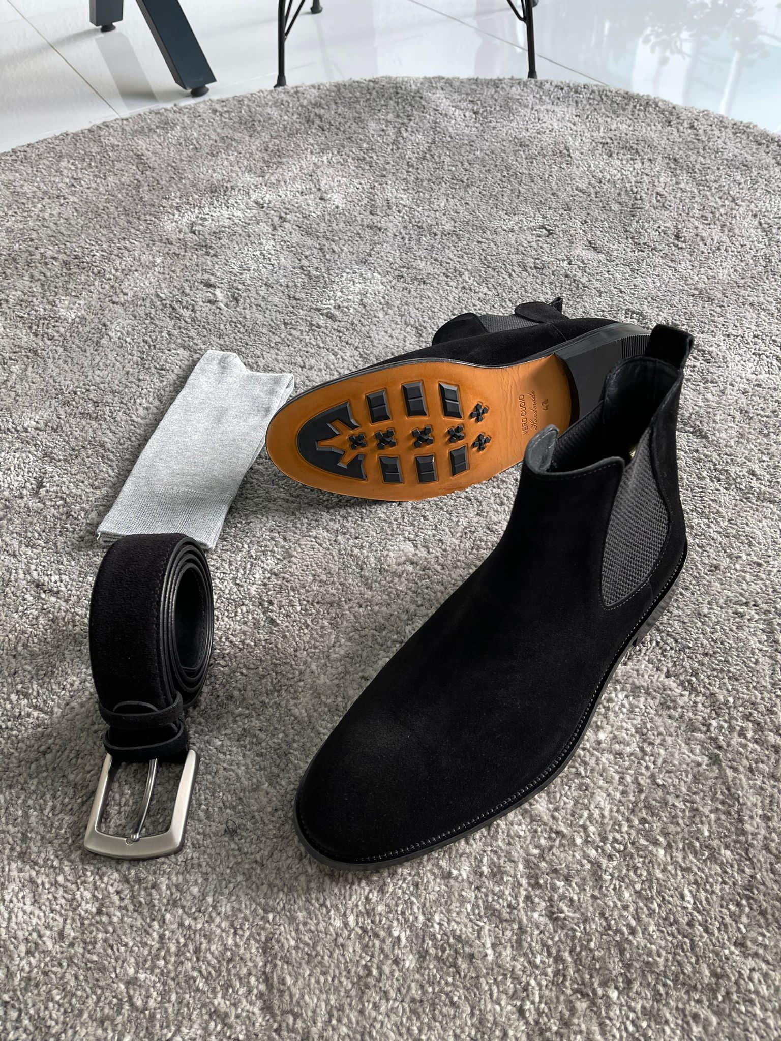 Handmade Classic Black Suede Chelsea Boots – one boot is positioned to highlight the distinctive orange EVA sole.