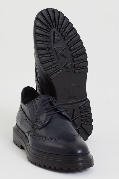 Navy Blue Brogue Derby Shoes – one shoe showing the textured black EVA sole for grip, the other upright, highlighting comfort and versatility.