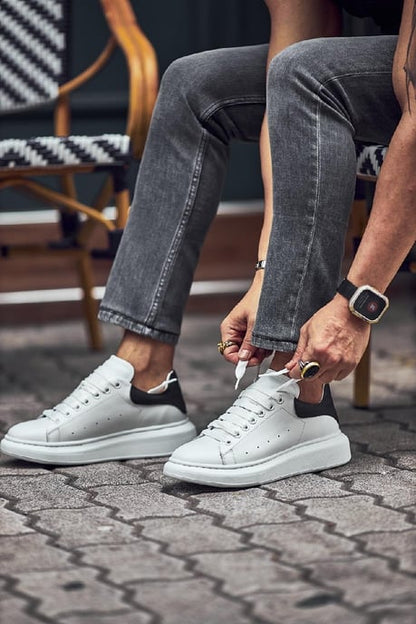 Handmade White Leather Sneakers - Luxury Comfort for Every Occasion – a man tying the laces, showcasing premium white leather and a contrasting black heel tab for a modern flair.