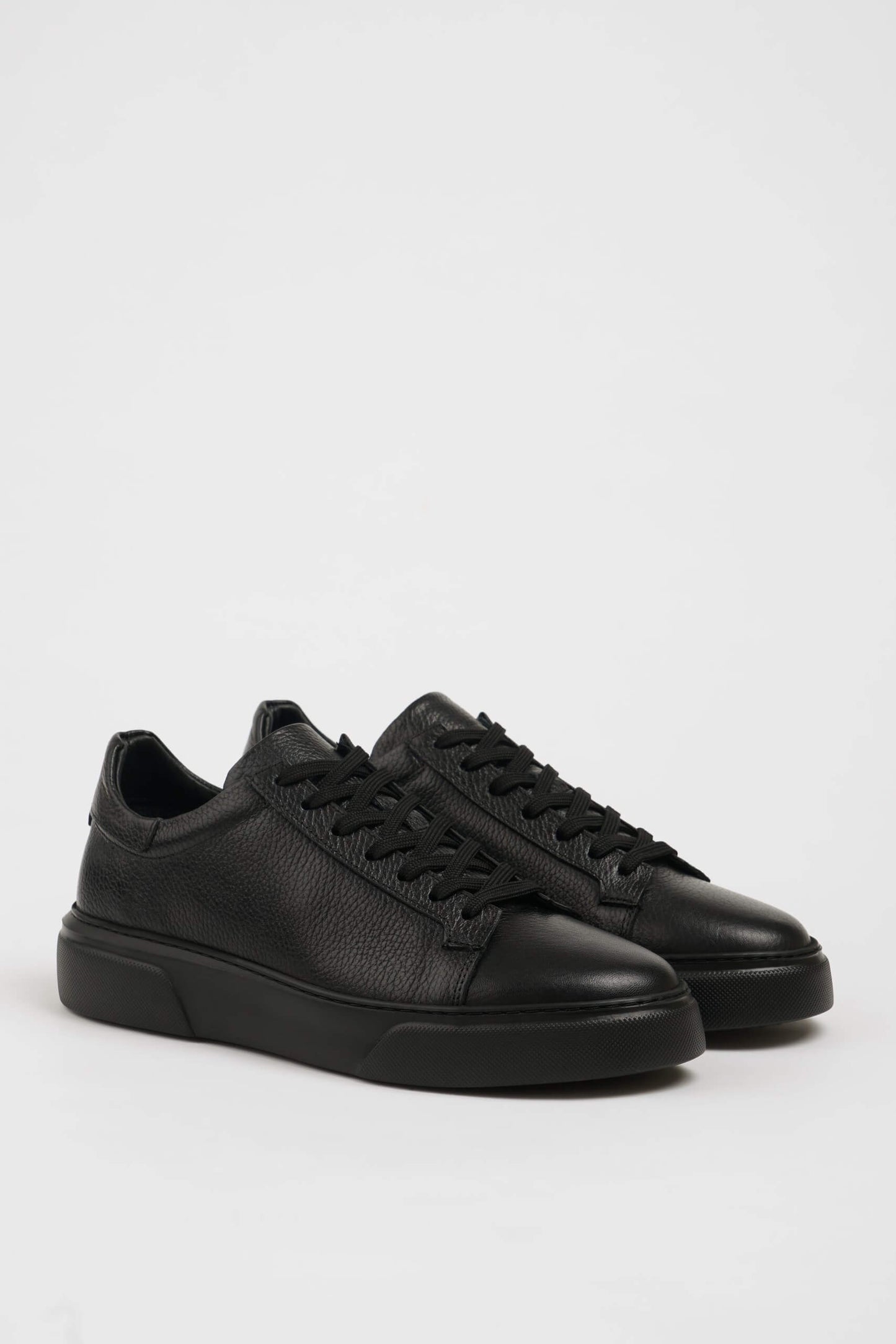 All Black Grained Leather Sneakers for Minimalist Style – pair on white background, showcasing rich black leather and sleek silhouette.