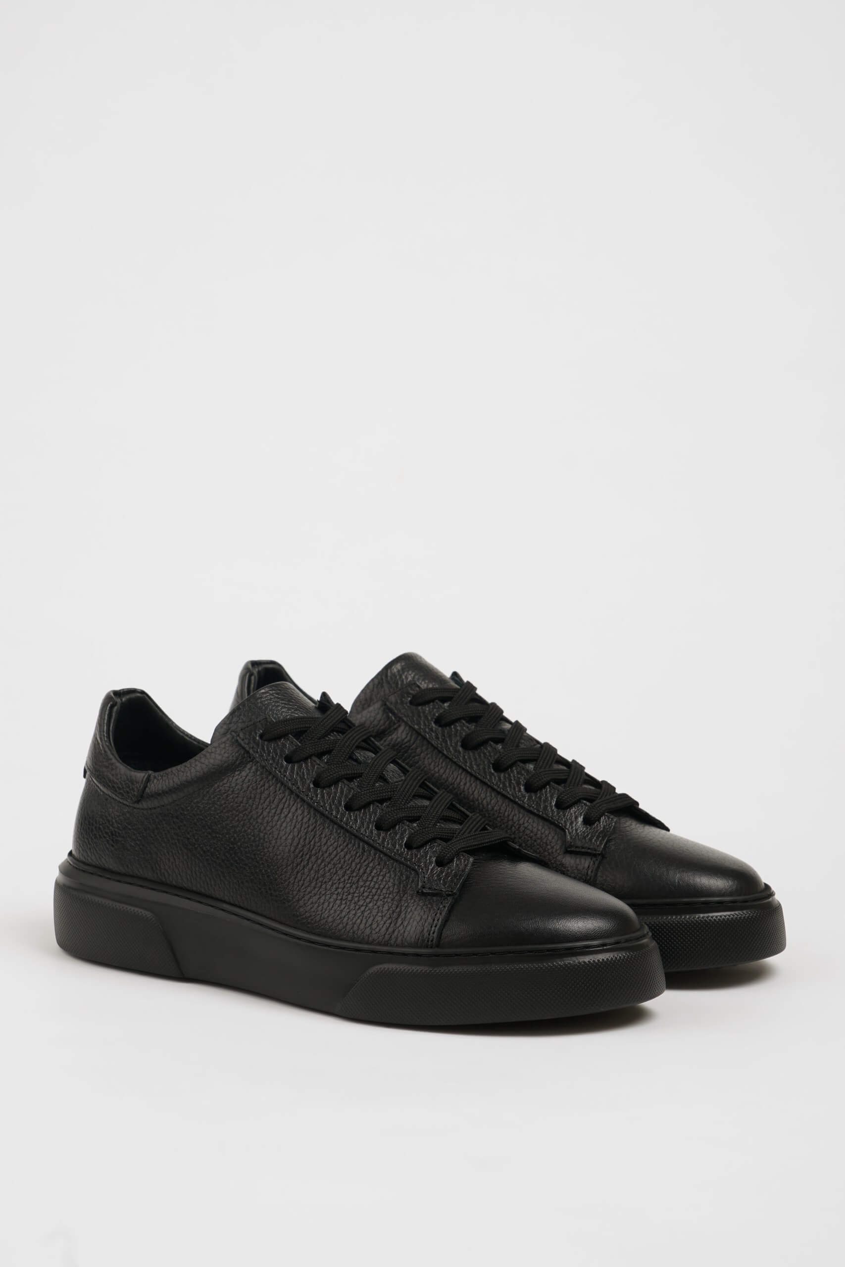 All Black Grained Leather Sneakers for Minimalist Style – pair on white background, showcasing rich black leather and sleek silhouette.