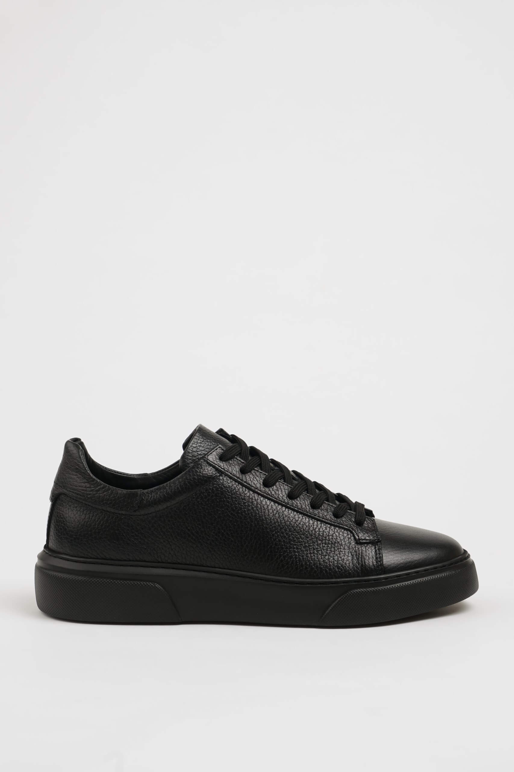 All Black Grained Leather Sneaker for Minimalist Style – side view on white background, showcasing rich black leather and all-black sole.