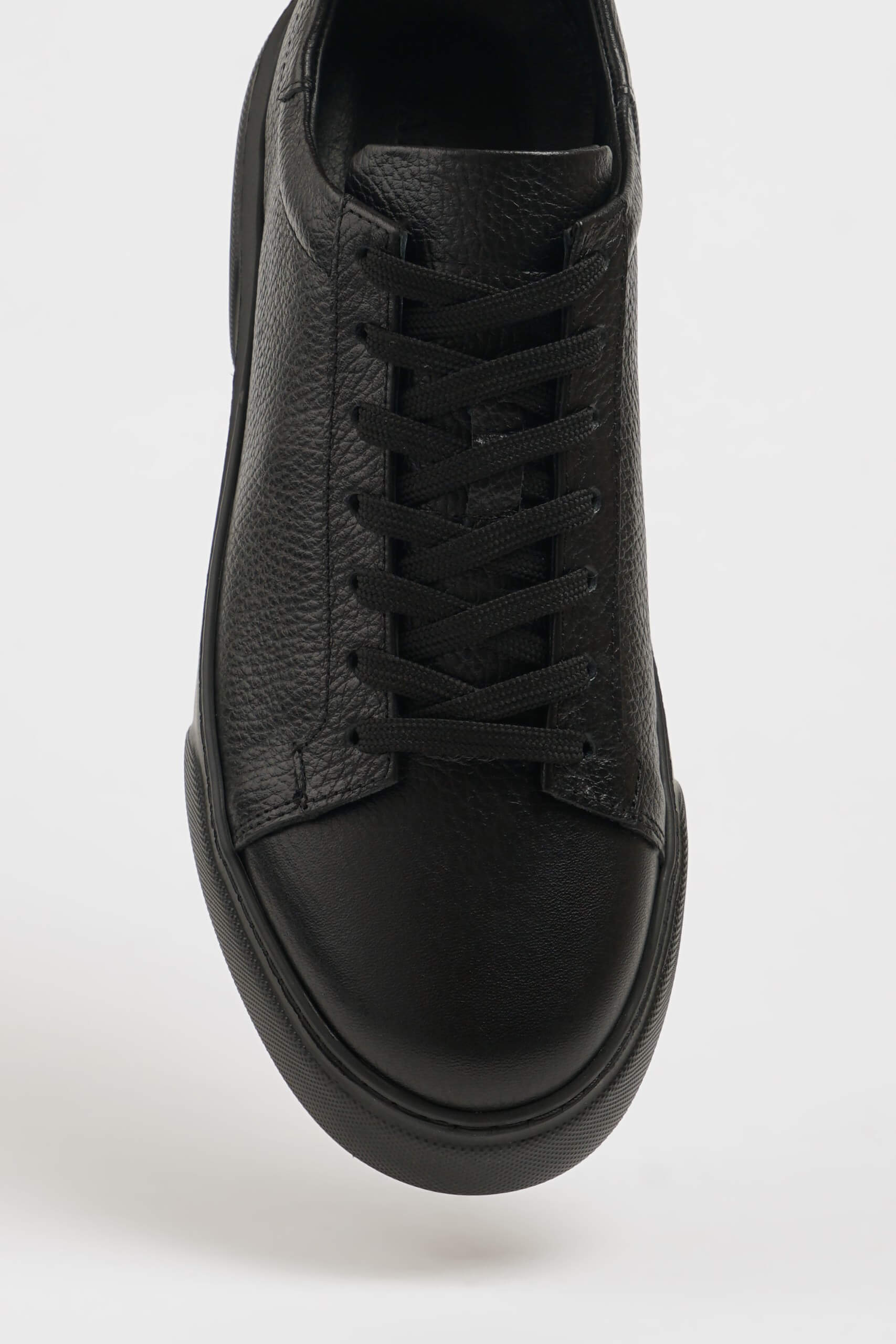All Black Grained Leather Sneaker for Minimalist Style – close-up top-down view, highlighting rich black leather upper and minimalist design.