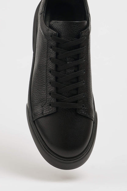 All Black Grained Leather Sneaker for Minimalist Style – close-up top-down view, highlighting rich black leather upper and minimalist design.