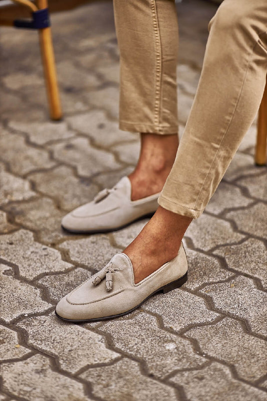 HolloShoe Beige Suede Tassel Loafers - Sophisticated Leather Footwear – worn by a man in tan chinos, standing on a paved ground, highlighting sophisticated tassel design and Eva rubber sole.