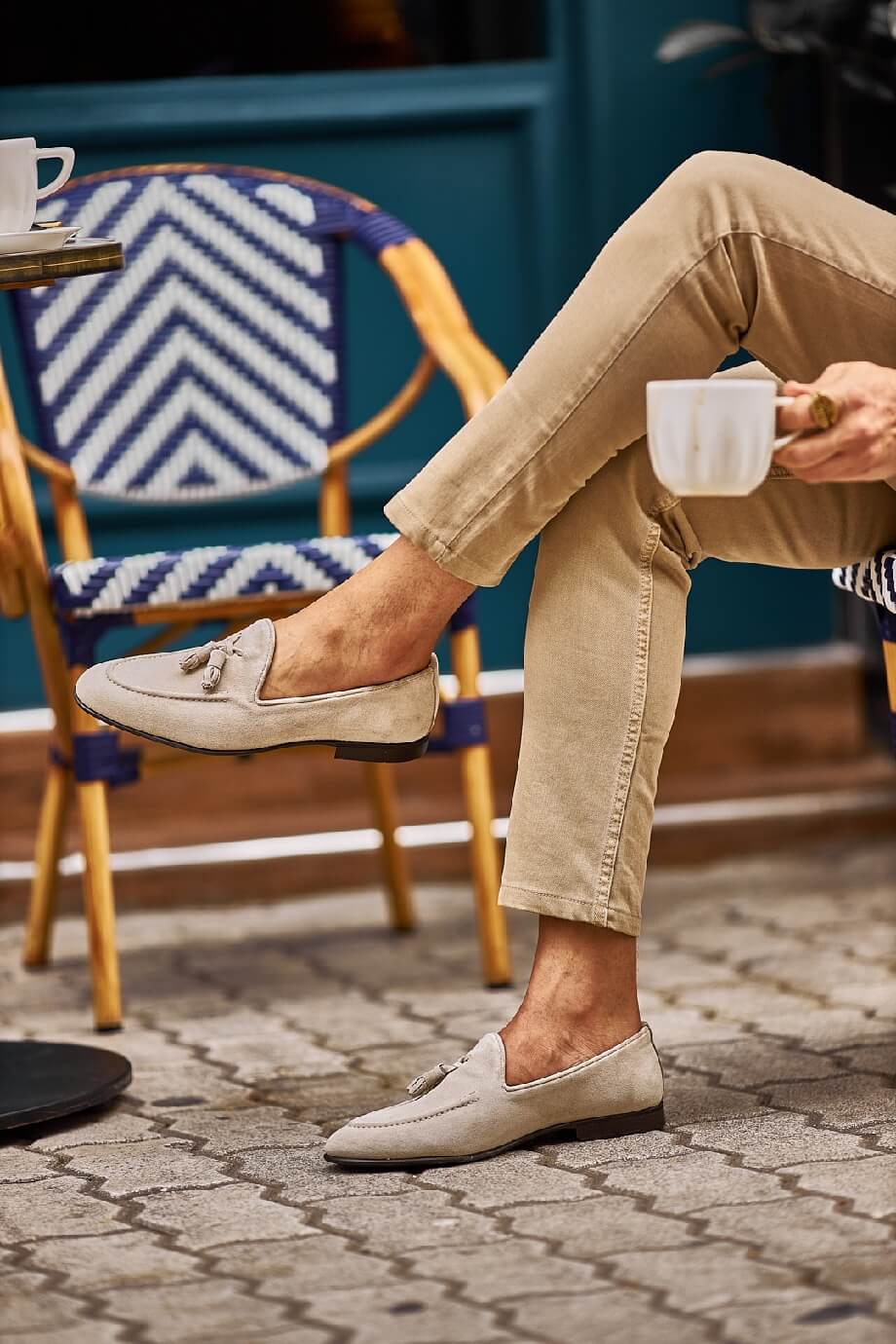 HolloShoe Beige Suede Tassel Loafers - Sophisticated Leather Footwear – worn by a man in tan chinos, sitting outdoors, showcasing a relaxed and comfortable fit.