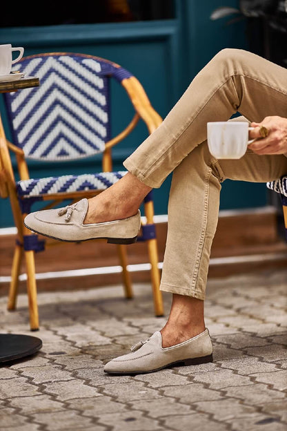 HolloShoe Beige Suede Tassel Loafers - Sophisticated Leather Footwear – worn by a man in tan chinos, sitting outdoors, showcasing a relaxed and comfortable fit.