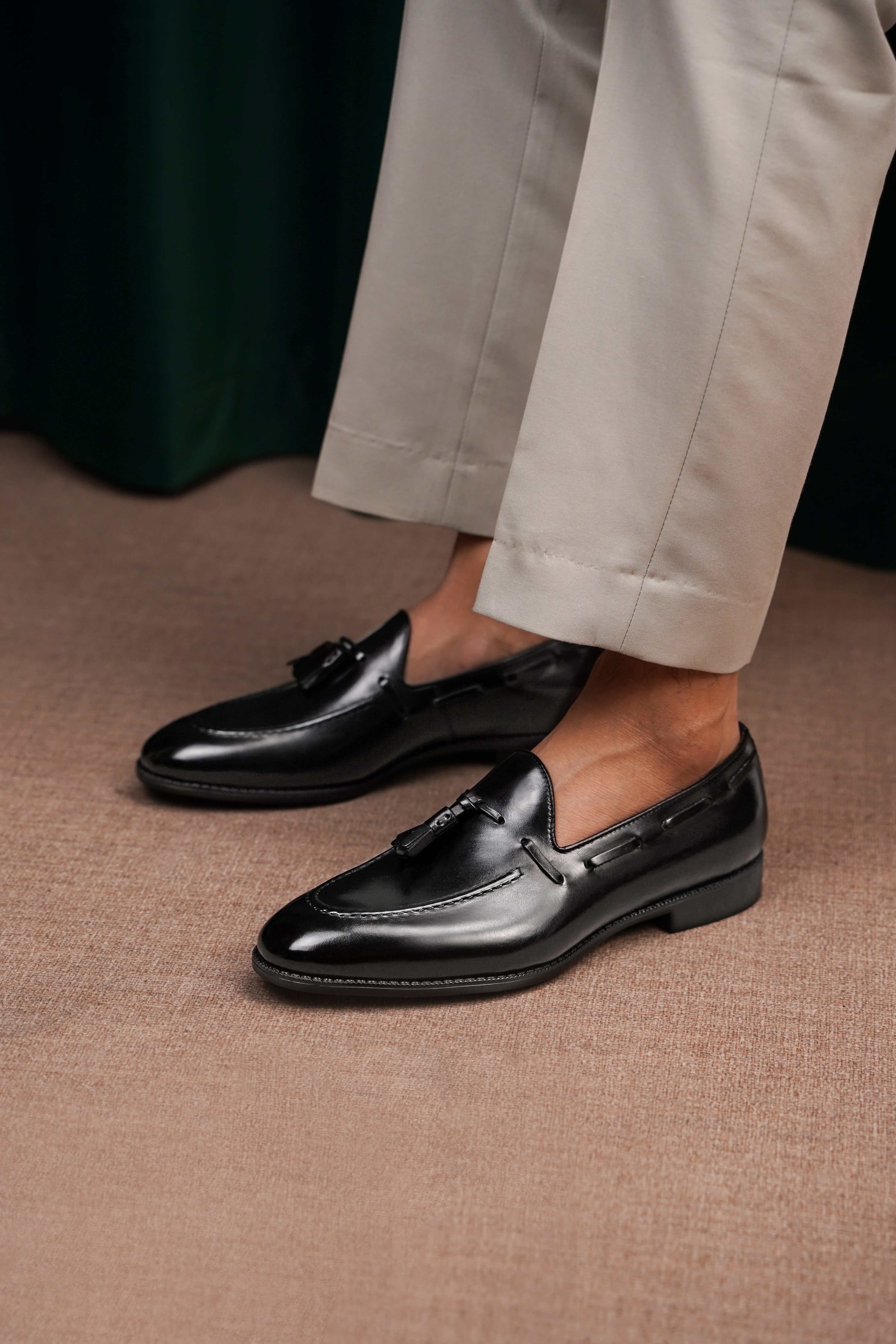 HolloShoe Handmade Black Tassel Leather Loafers – sleek black polished leather, worn by a man in light trousers, showcasing refined impact for evenings out.