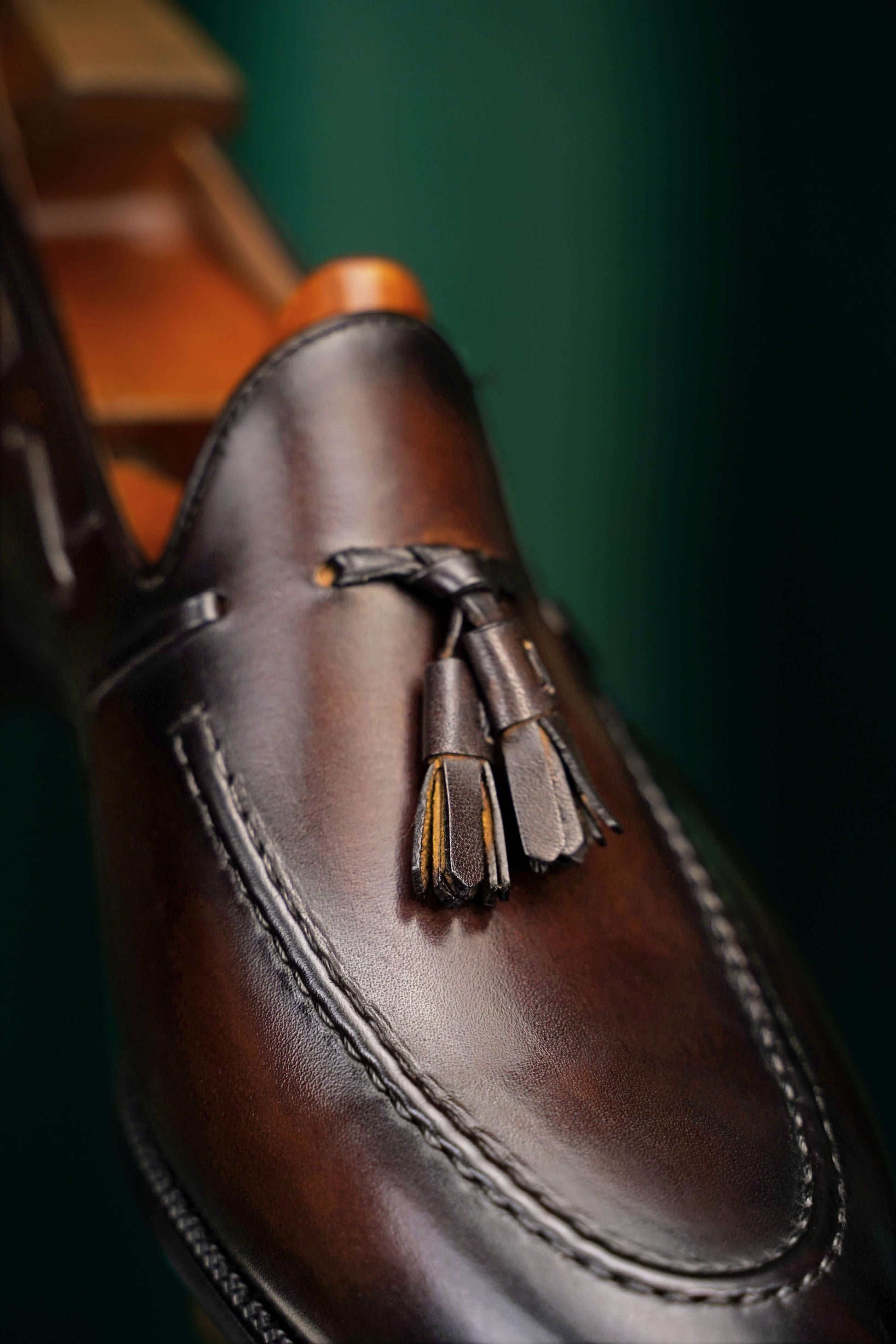 HolloShoe Handmade Chestnut Brown Patina Tassel Loafer – close-up of classic tassels and burnished dark brown leather, emphasizing timeless refinement.