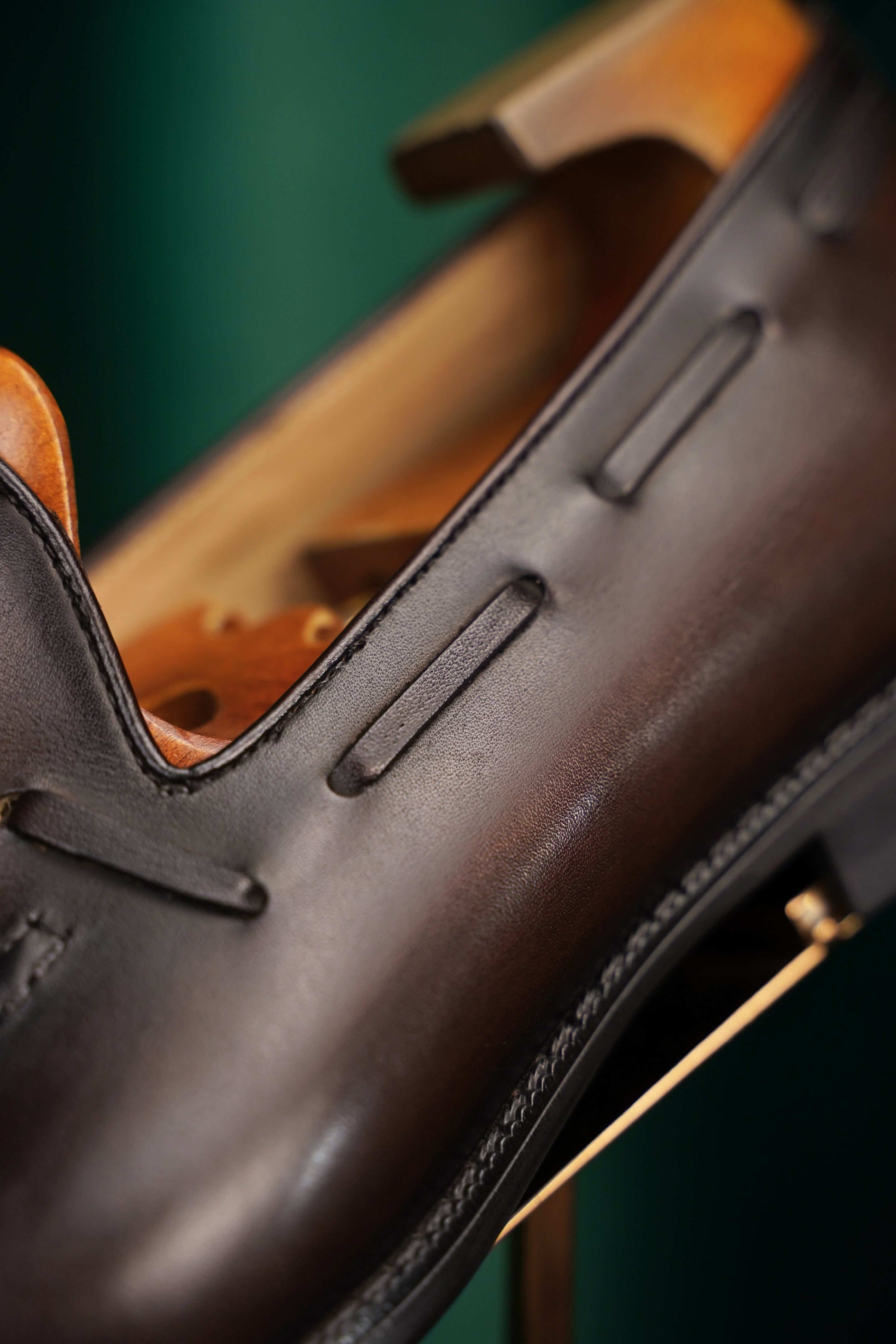 HolloShoe Handmade Chestnut Brown Patina Tassel Loafer – close-up of the side lacing and burnished dark brown leather, showcasing meticulous craftsmanship.