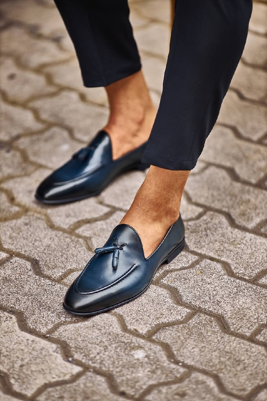 HolloShoe Navy Blue Tassel Loafers - Sophisticated Leather Footwear – worn by a man in black trousers, standing on a paved ground, showcasing an elegant navy blue hue and refined design.