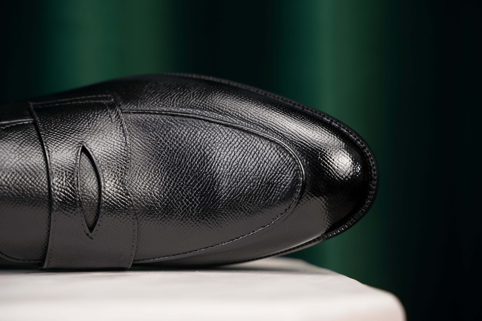HolloShoe Black Penny Loafer – close-up of textured full-grain black leather upper with polished toe and refined penny slot detail.