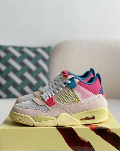 Union LA x Air Jordan 4 'Guava Ice' sneakers with a beige suede upper, vibrant pink, blue, and yellow accents, and vintage-inspired yellow midsole