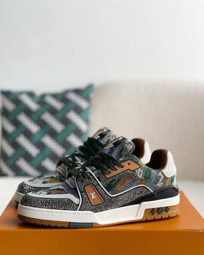 Louis Vuitton LV Trainer Sneaker with intricate beaded detailing, featuring a mix of earthy tones including green, brown, and white, with premium leather accents and a gum outsole, 