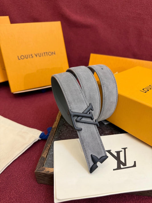 Gray belt with a prominent logo on a maroon surface with Louis Vuitton packaging.