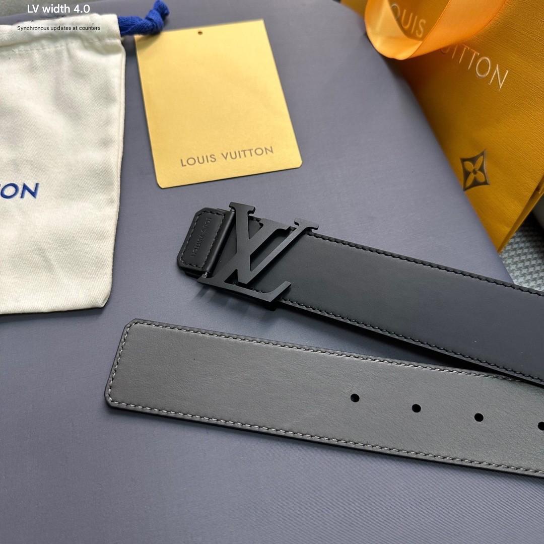Louis Vuitton belt with logo buckle on a gray surface, surrounded by branded materials.