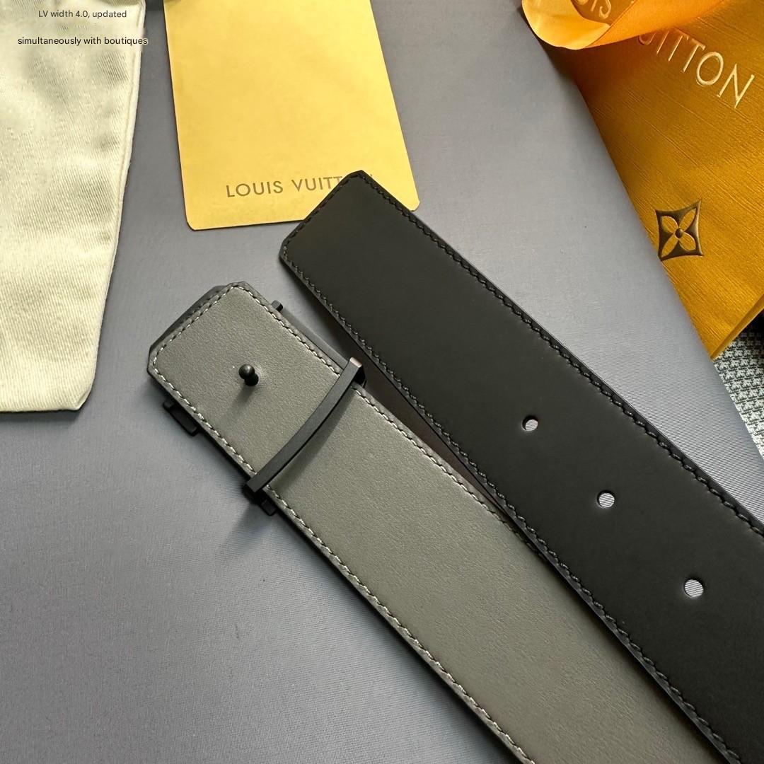 Black leather belt on a gray surface with Louis Vuitton packaging in the background.
