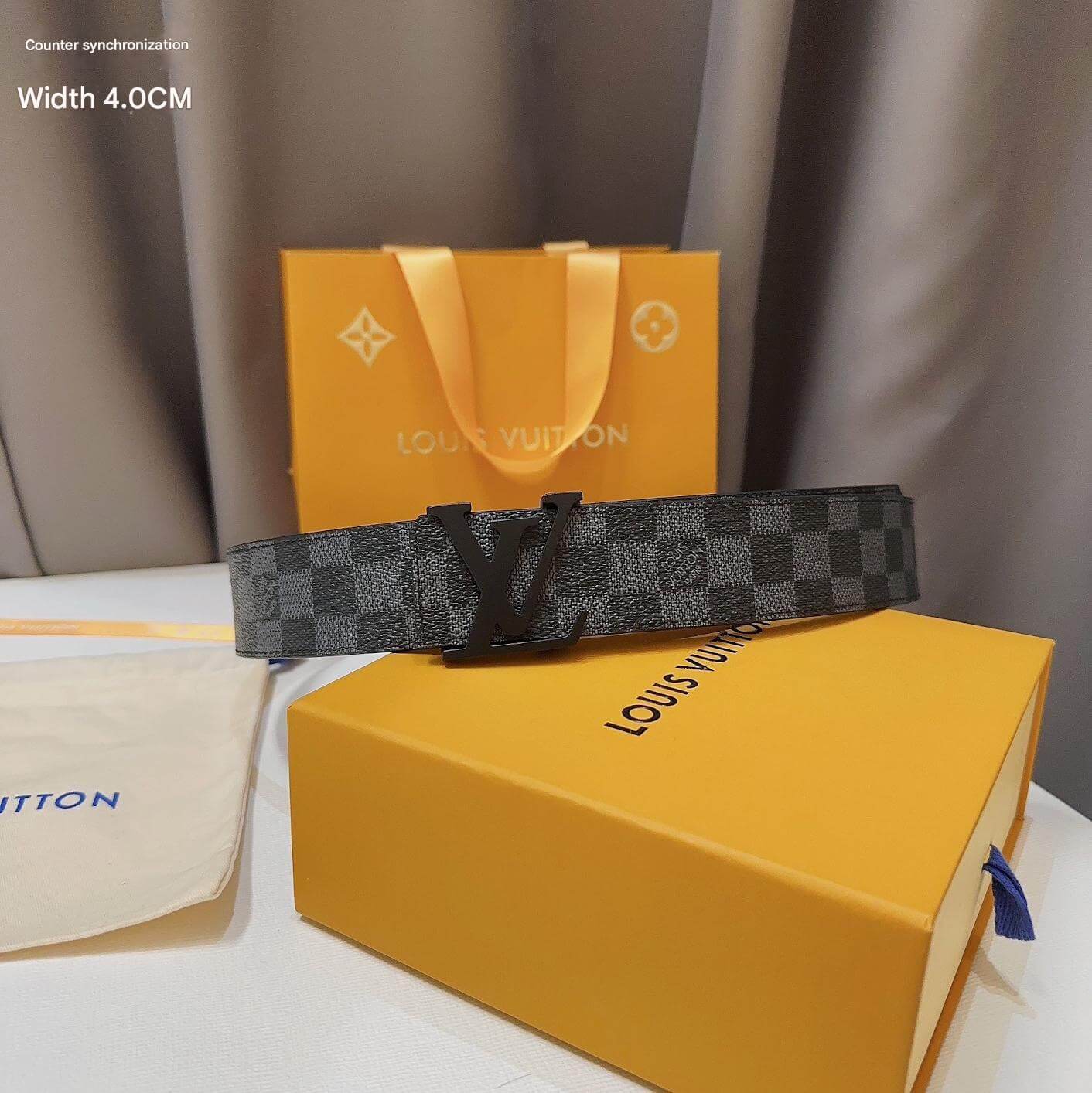 Louis Vuitton belt and packaging on a neutral background