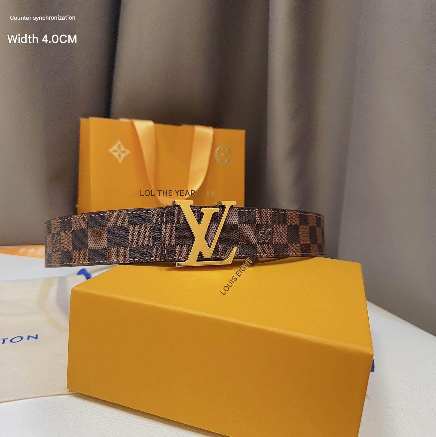 Louis Vuitton belt on a yellow box with brand packaging in the background