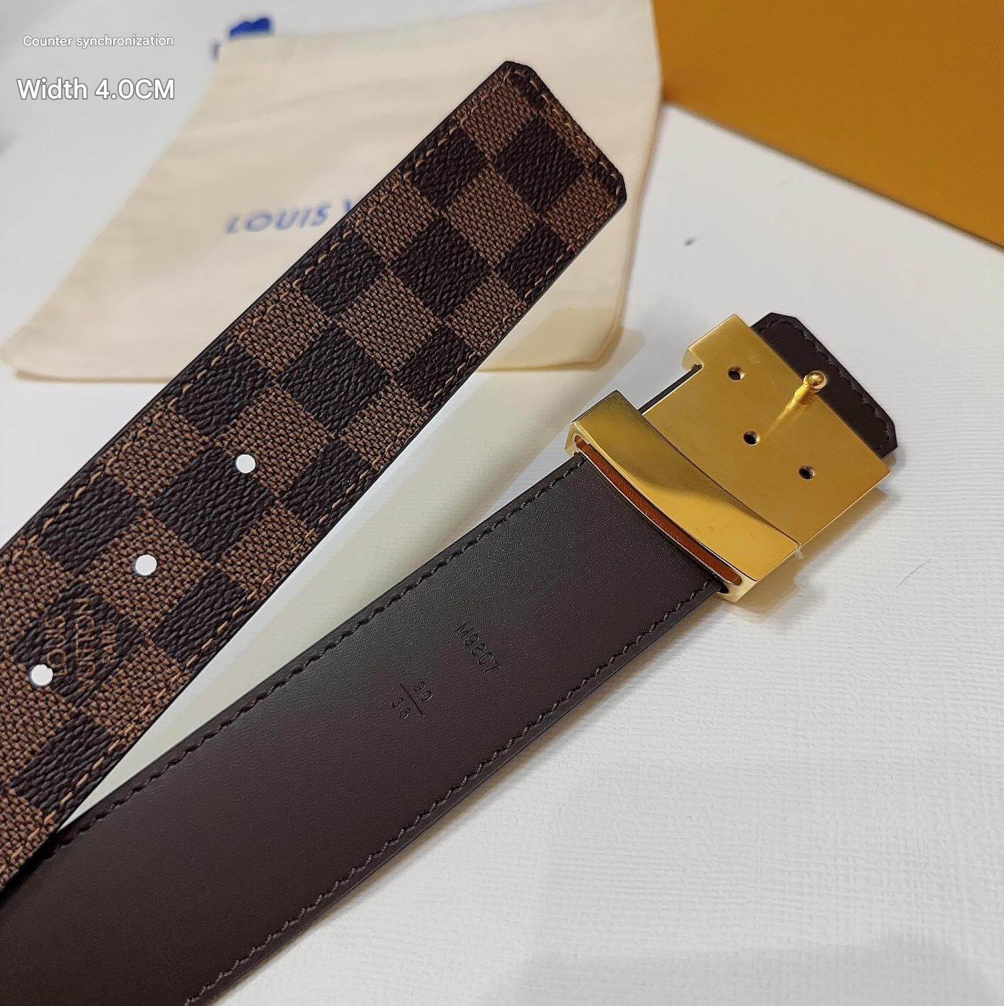 Brown checkered belt with gold buckle on a white surface