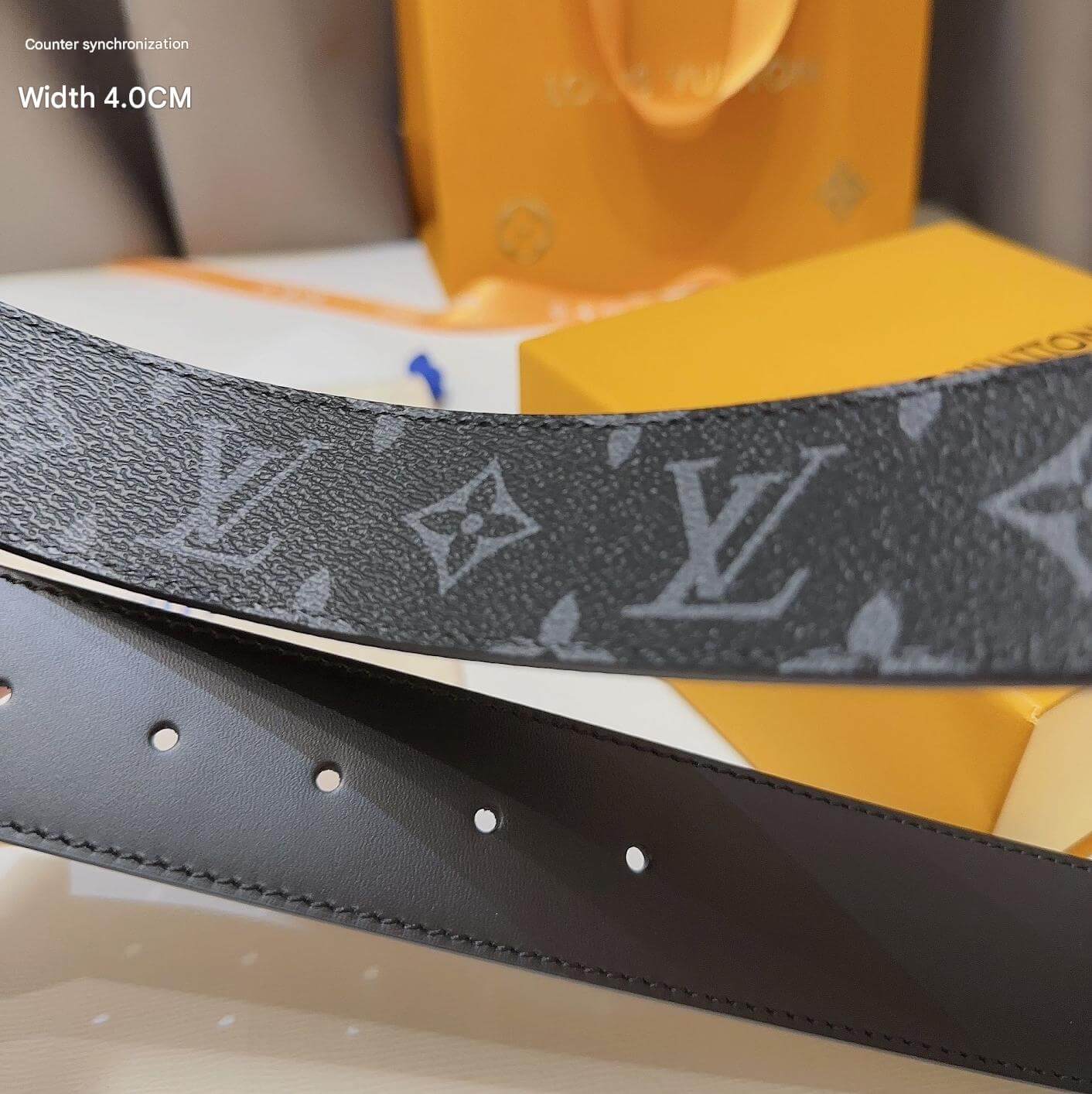 Louis Vuitton belt with monogram pattern on a branded box