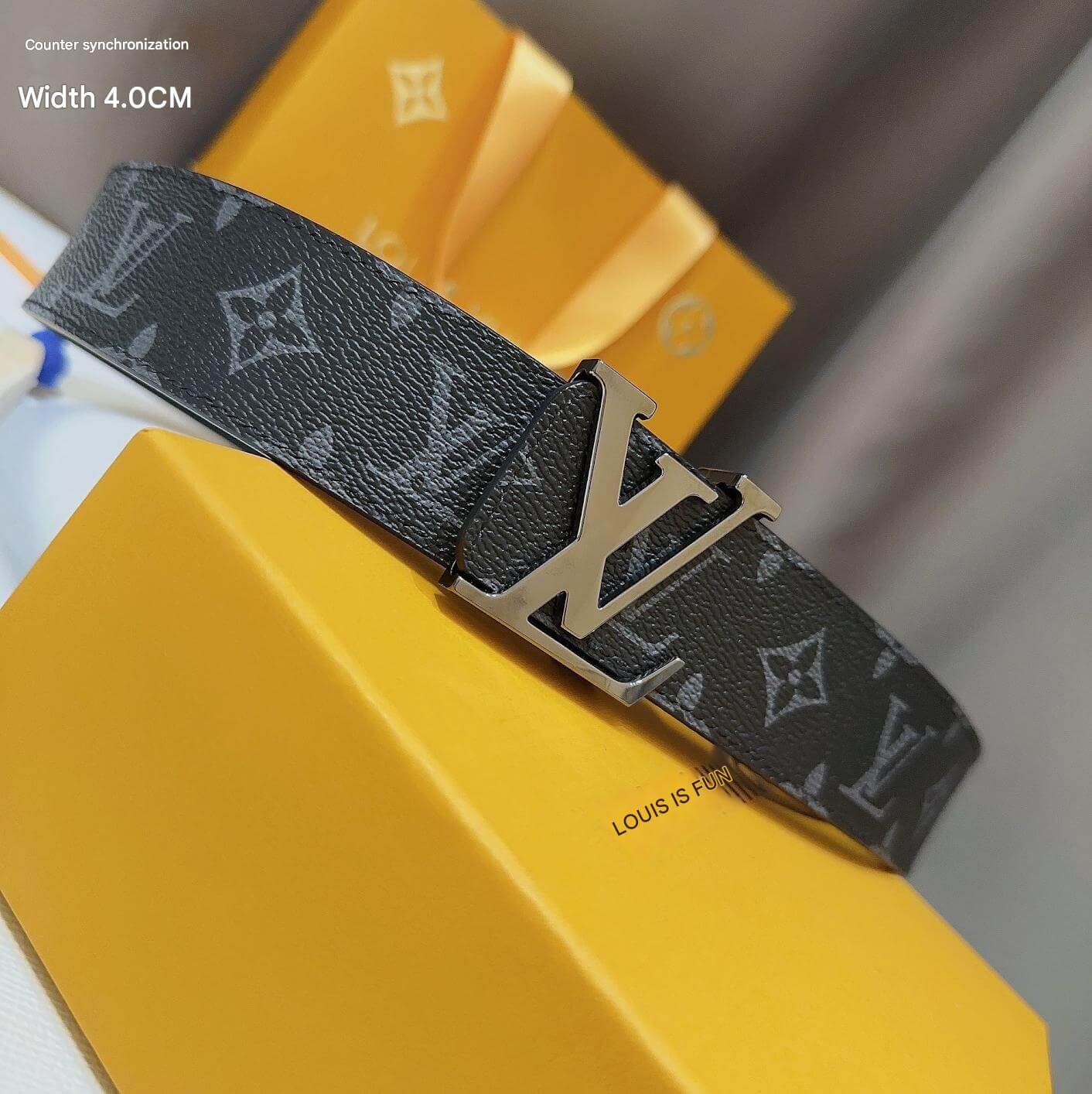 Louis Vuitton belt with monogram strap on a yellow box