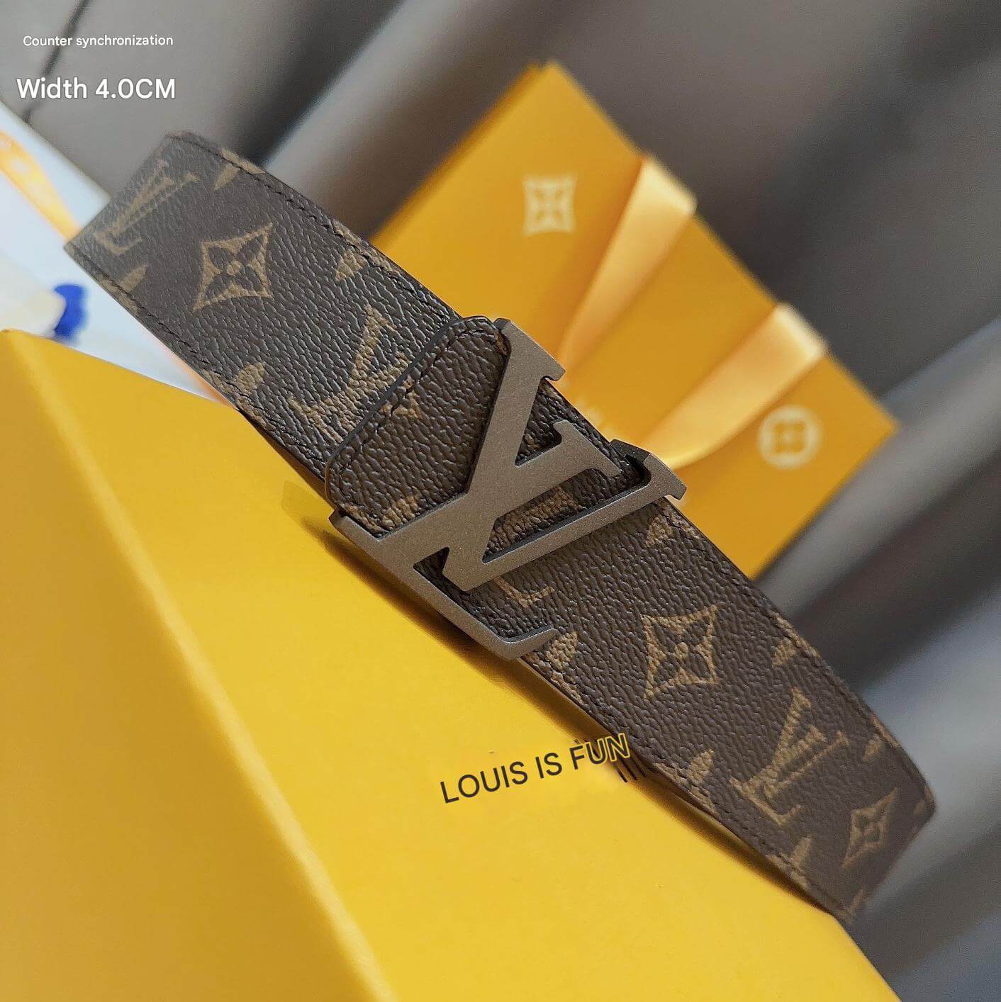 Brown patterned belt with a prominent buckle on a yellow surface