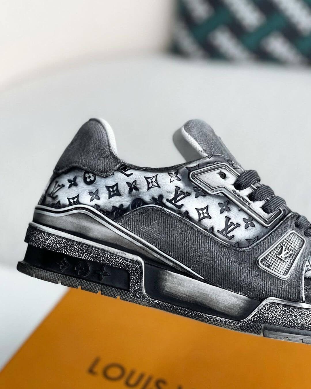 Louis Vuitton LV Trainer Sneakers in a black and white gradient design with iconic monogram pattern and premium leather detailing