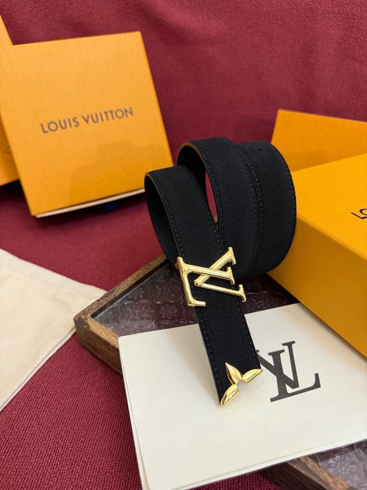 Black belt with gold buckle on a Louis Vuitton box and paper