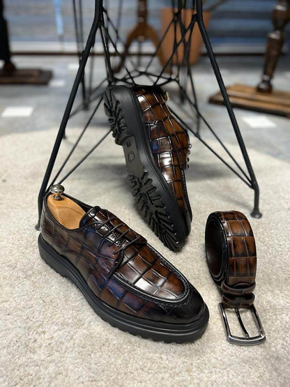 Luxurious Brown Crocodile Leather Shoes – pair on a white rug with shoe trees and matching textured belt, showcasing striking pattern and elegance