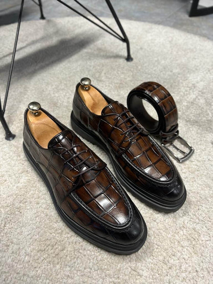 Luxurious Brown Crocodile Leather Shoes – pair on a white rug, top-down view, highlighting the rich brown hue and distinctive texture.