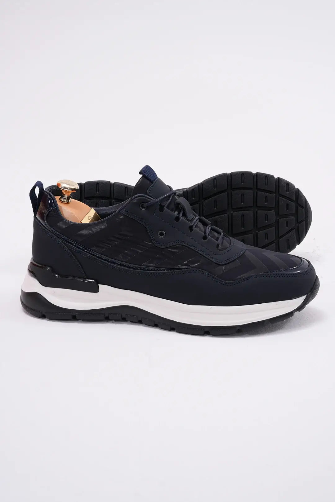 Midnight Motion Luxe Sneakers for Urban Energy – side view of pair, with one shoe showing the textured black sole for reliable traction, the other upright.
