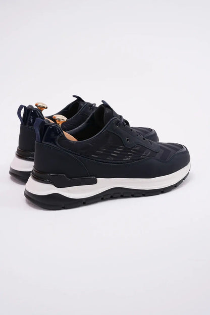 Midnight Motion Luxe Sneaker for Urban Energy – pair from a back-side angle, highlighting premium midnight blue leather with subtle geometric texture and a white EVA sole.
