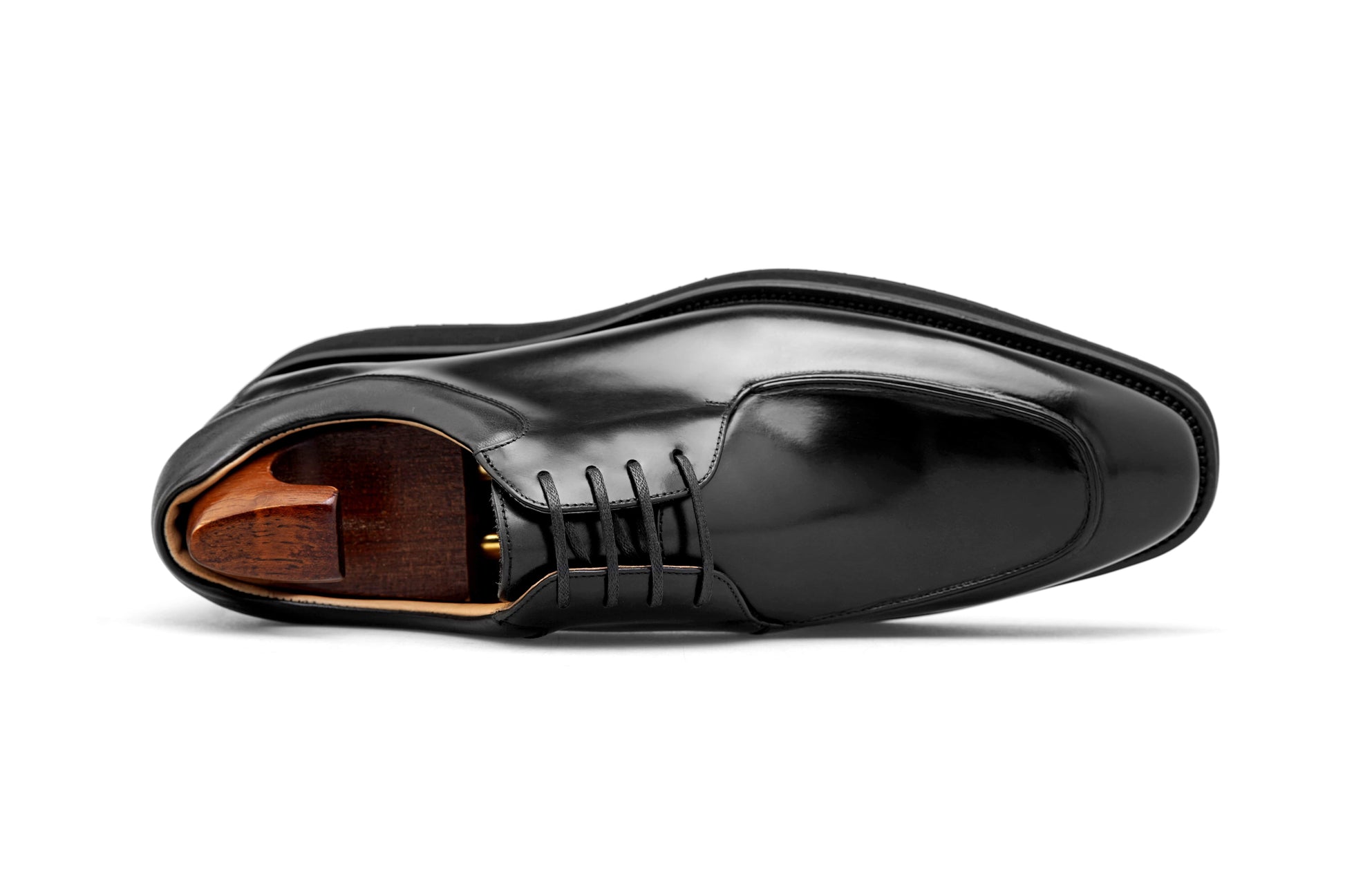 Overhead view of a pair of HolloShoe Black Apron-Toe Derby shoes, showcasing their sleek design and high-shine black leather finish.