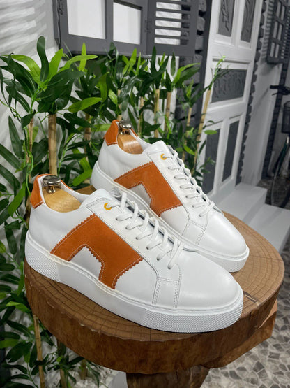 Modern White Orange Sneakers for Everyday Casual Wear – pair displayed on a wooden stand, with a contrasting orange accent and a touch of understated cool.