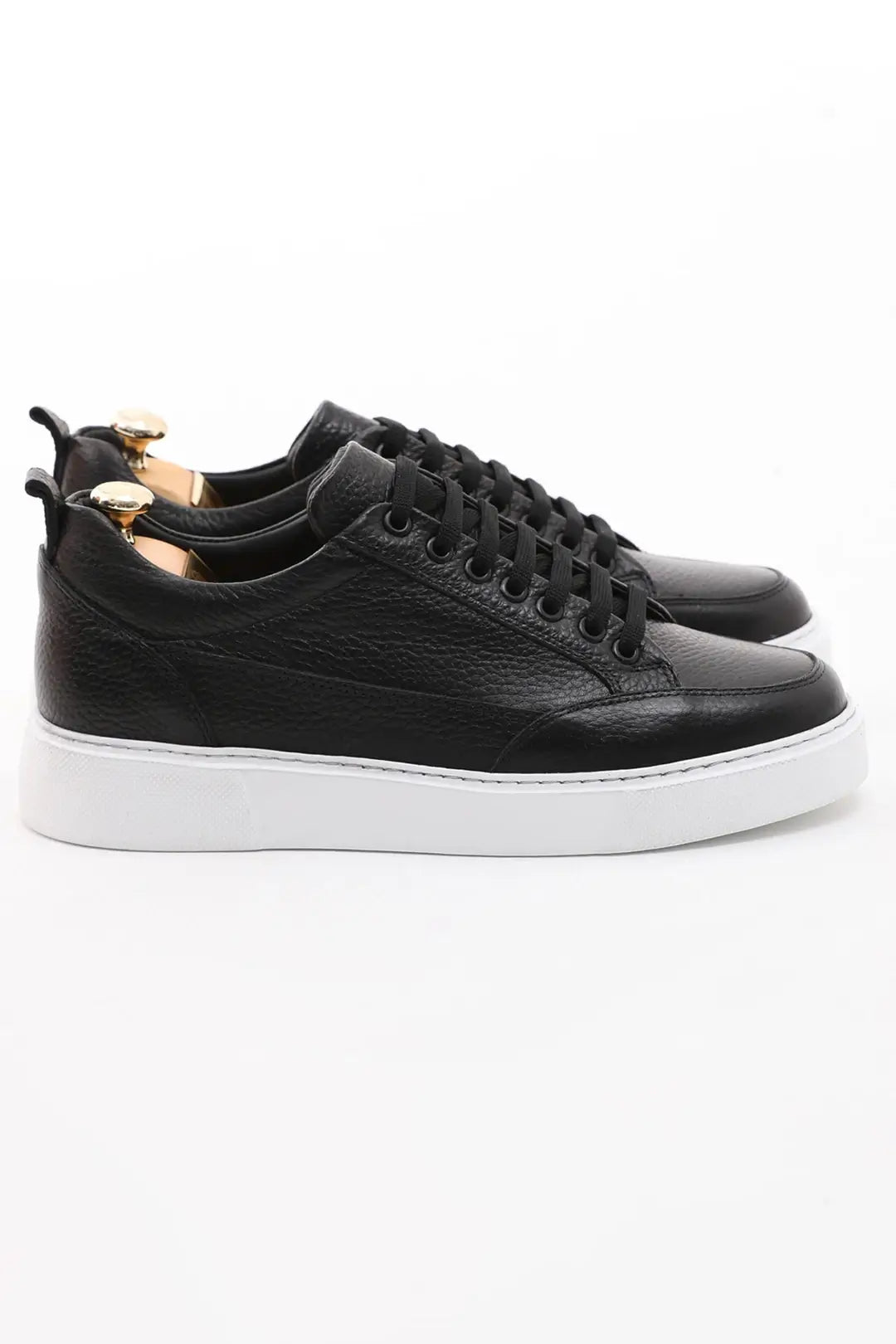 Onyx Luxe Black Leather Sneaker - Elegant Men's Footwear – side profile of one shoe, showcasing premium black floater leather and a contrasting white sole.